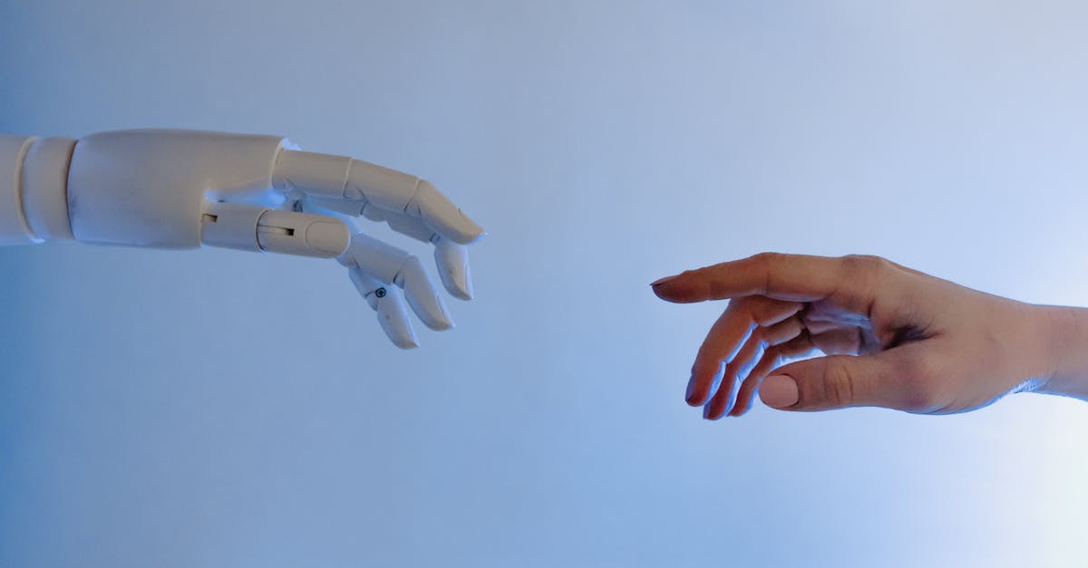 A human hand reaching towards a robotic hand symbolizing technology and connection.