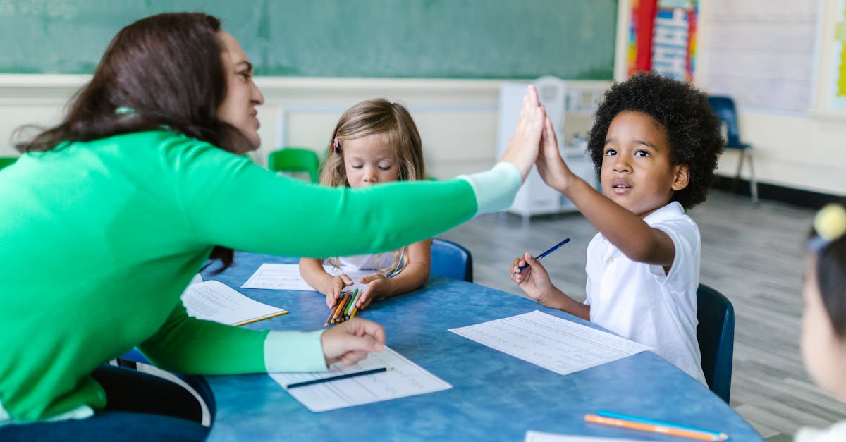 A teacher and students enjoying a high five during a classroom learning activity.