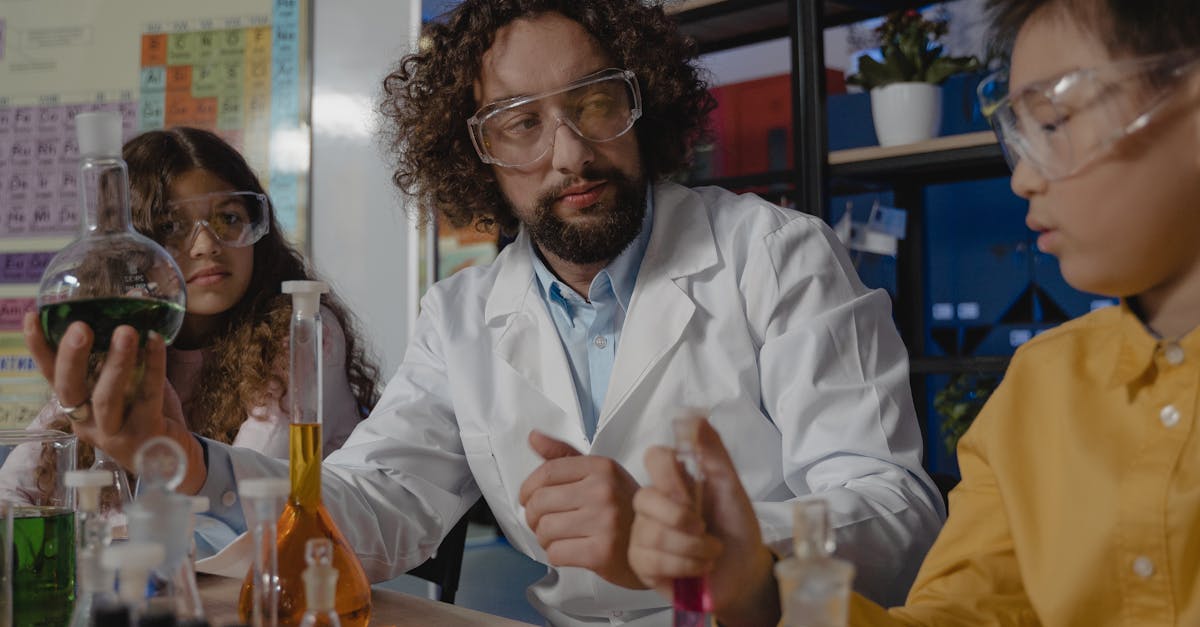 Students and teacher conducting a colorful science experiment using lab glassware in a classroom setting.