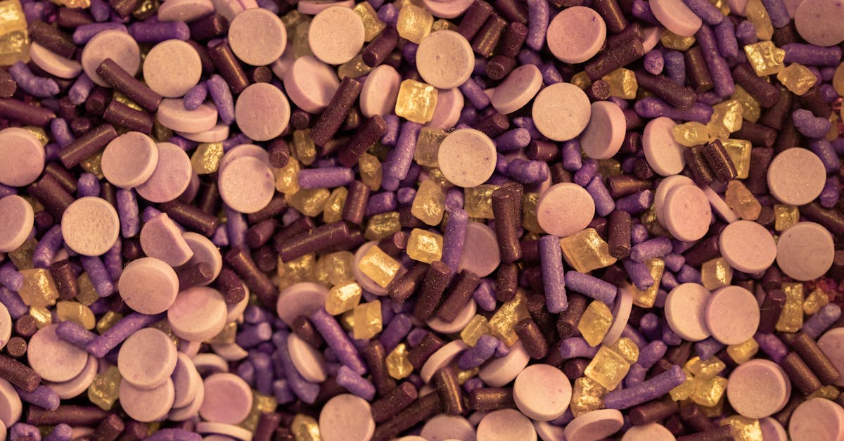A vibrant close-up of various candy and sprinkles in purple and gold hues.
