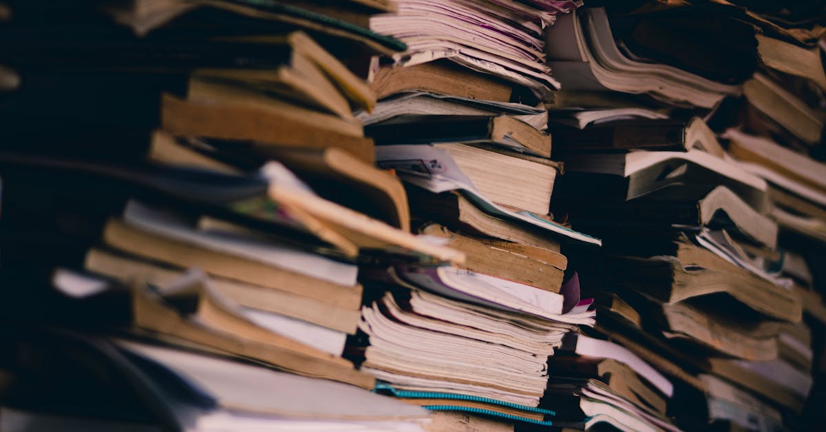 A chaotic stack of various books and papers showcasing abundance and disorganization.