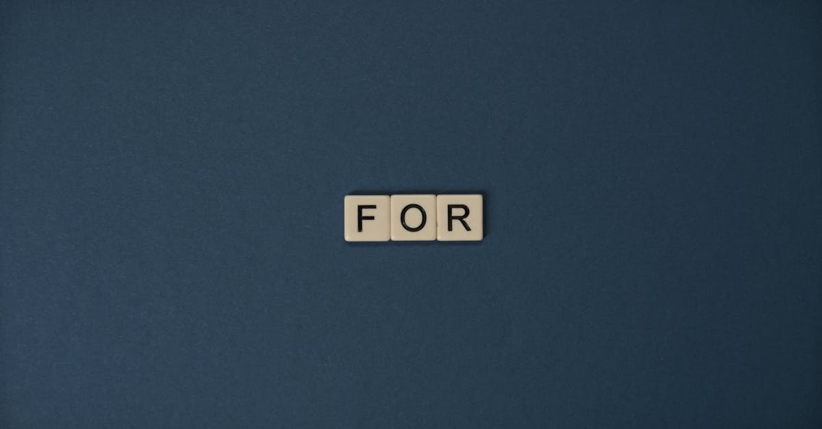 Artistic display of Scrabble tiles spelling the word 'For' on a dark background.