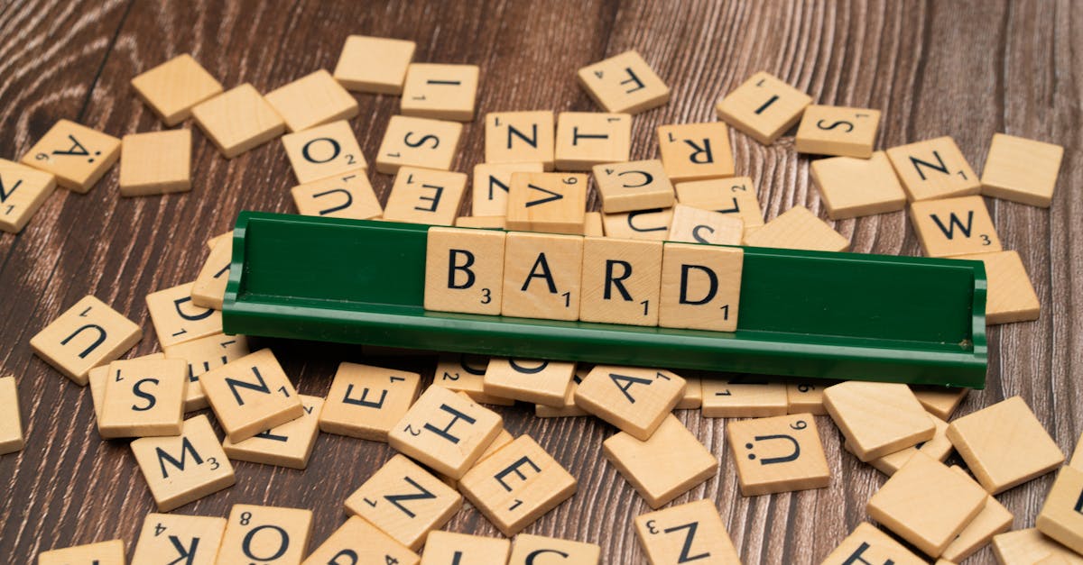 Scattered wooden tiles displaying letters with the word BARD on a green rack.