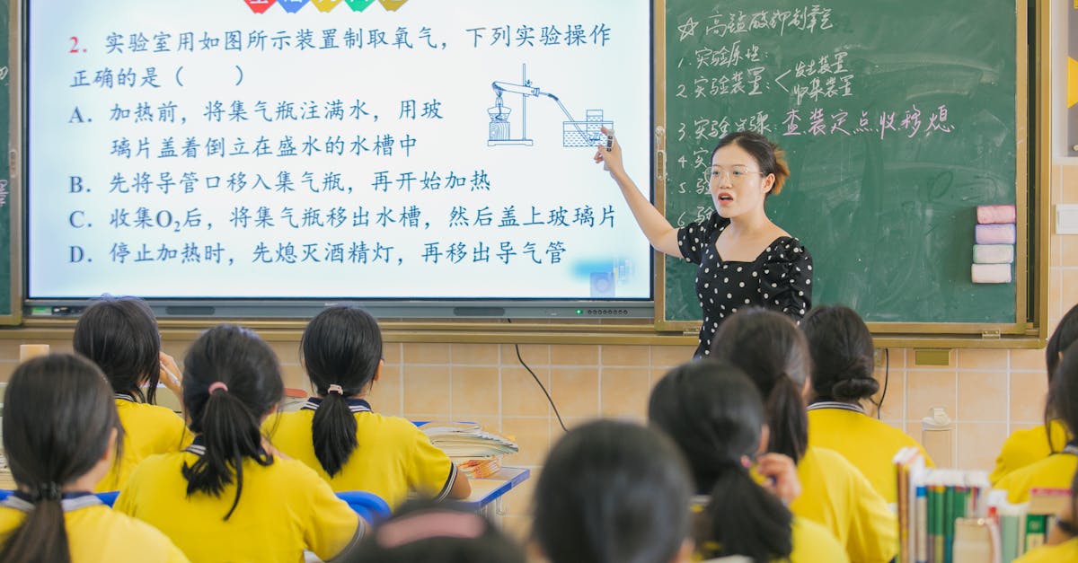 A teacher instructs students in a chemistry class, using a digital board for interactive learning.