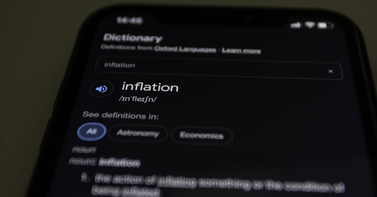 Close-up of a smartphone screen showing the word inflation defined in a dictionary app.