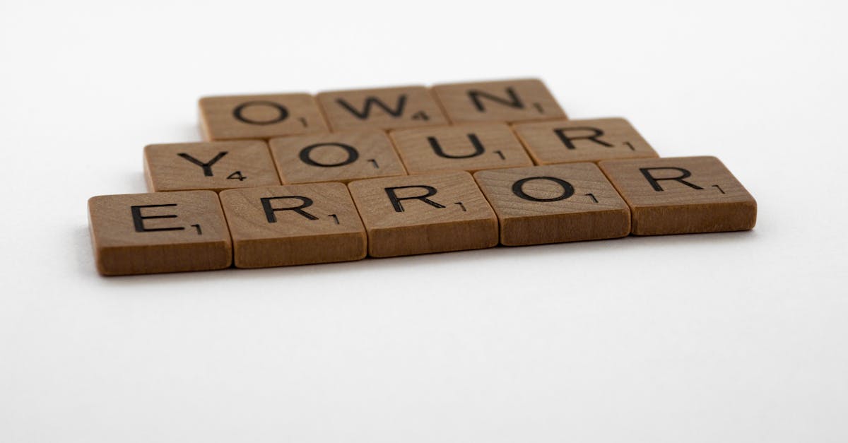 A motivational phrase assembled with Scrabble tiles on a white background.