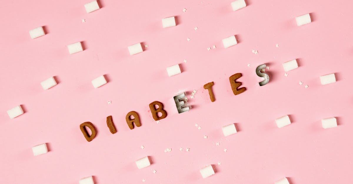 Artistic diabetes awareness design featuring sugar cubes and text on pink background.