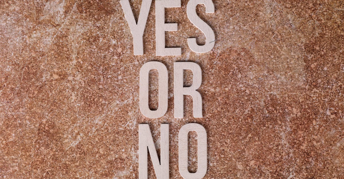 Wooden letters on marble background spell 'YES OR NO' symbolizing choices.