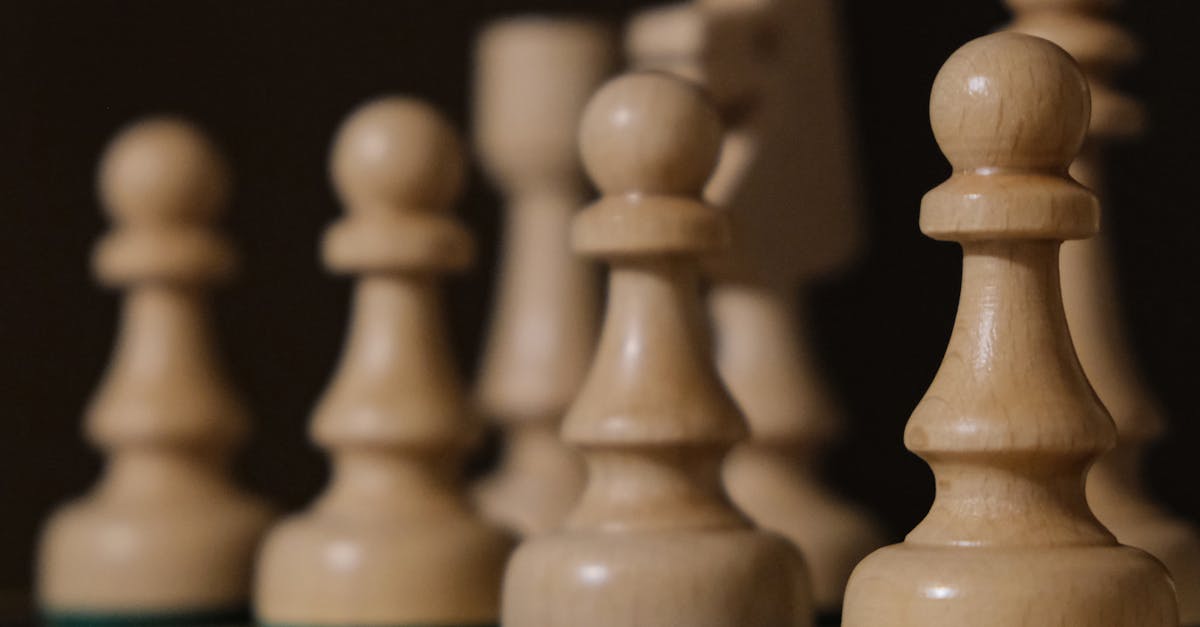 Close-up of chess pieces on board, highlighting pawns in strategic arrangement.