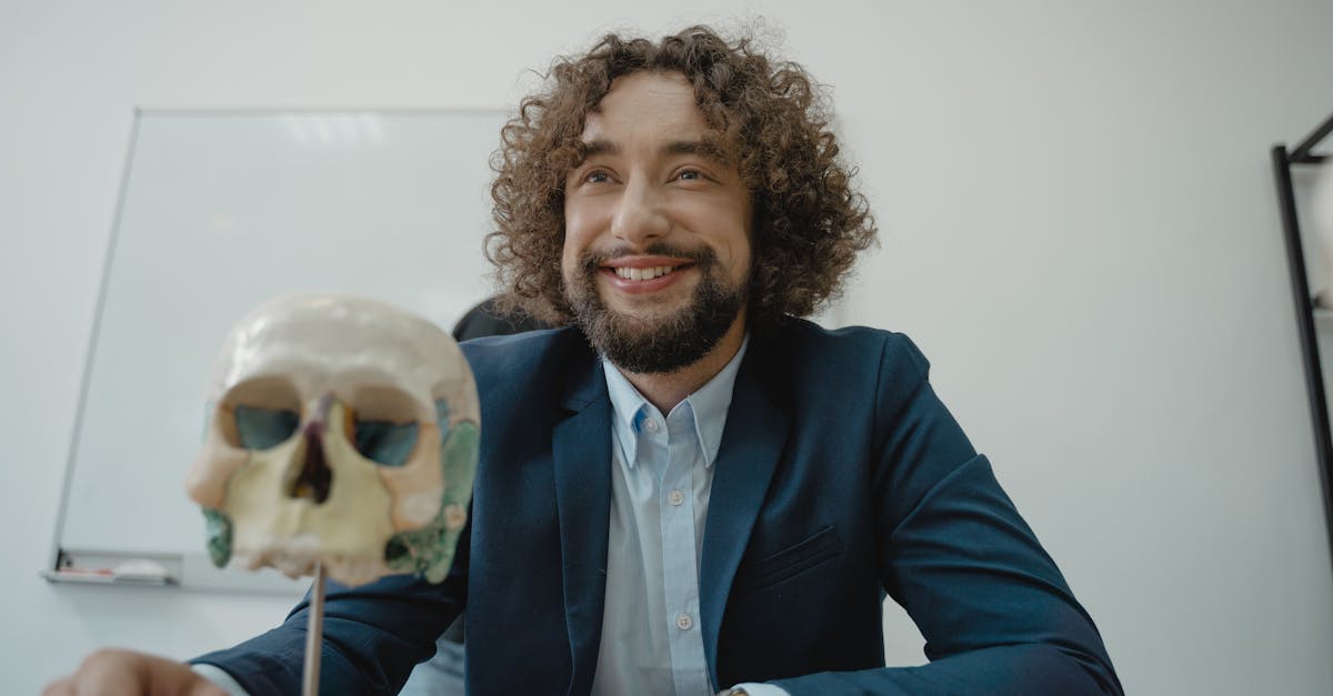 Engaging teacher with a model skull in a classroom, symbolizing knowledge and science education.