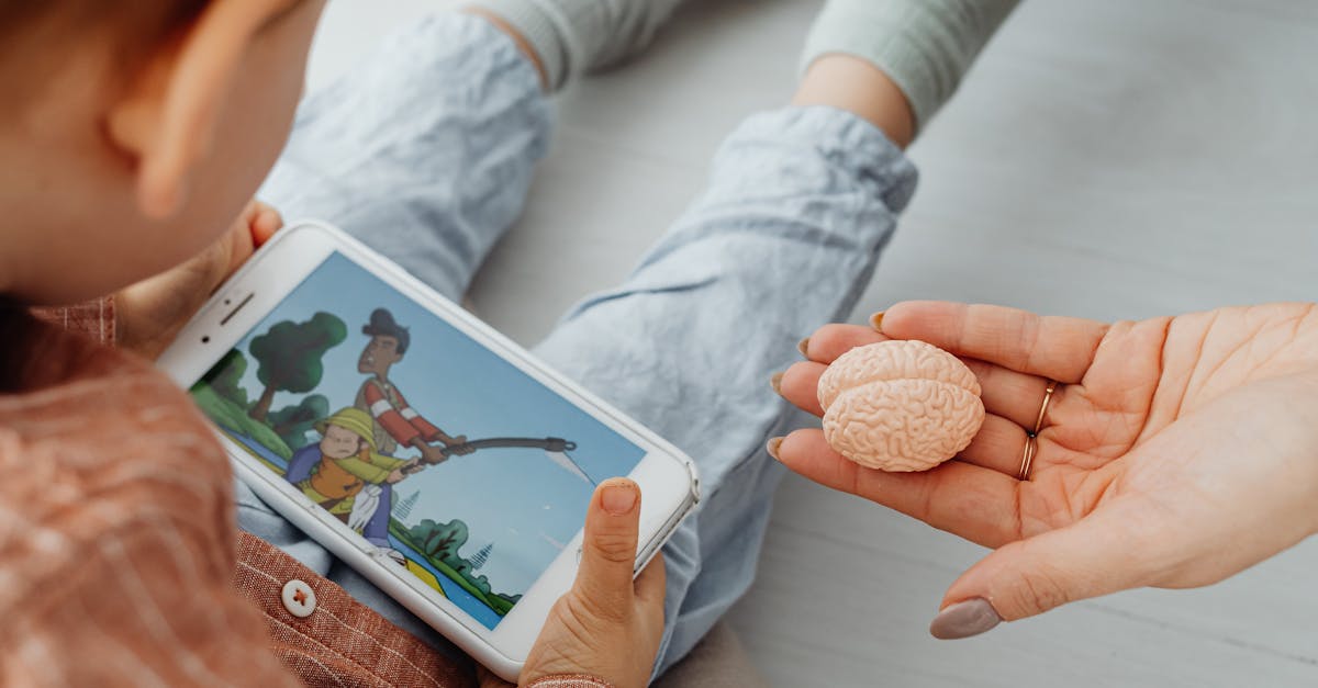 A child watches a cartoon on a smartphone indoors.