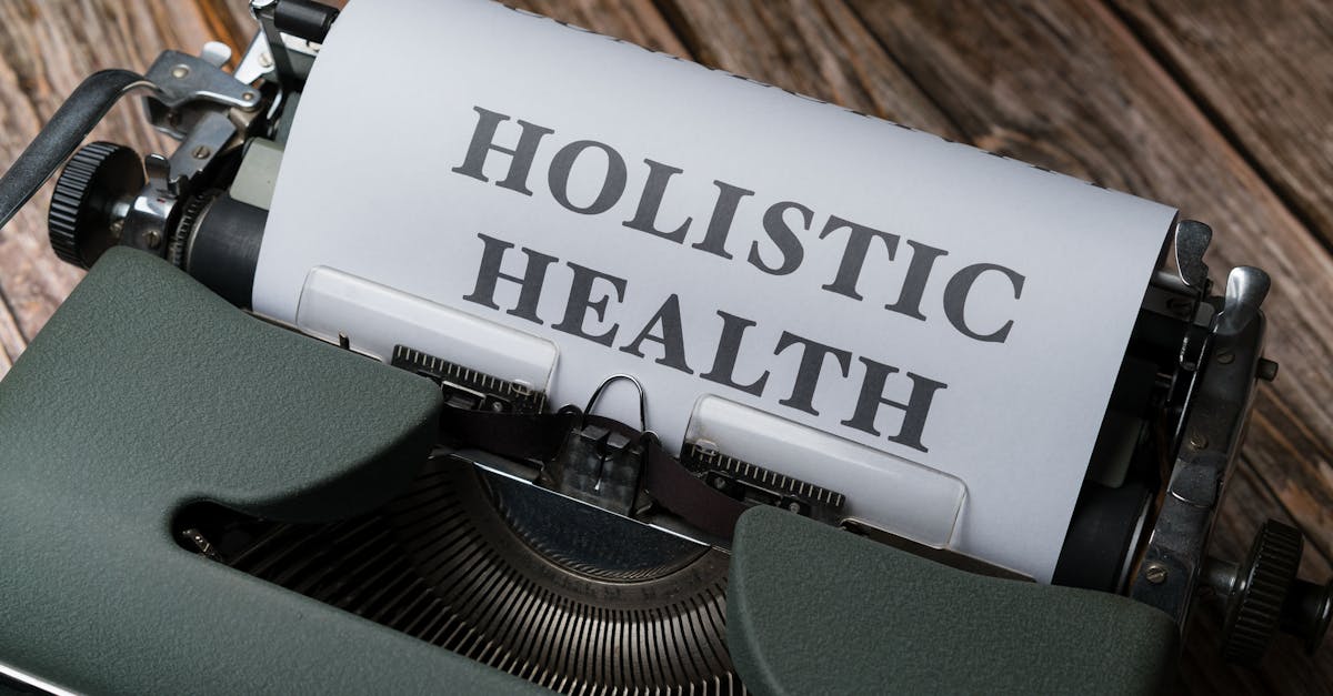 Close-up of a vintage typewriter with 'Holistic Health' on paper, representing wellness.
