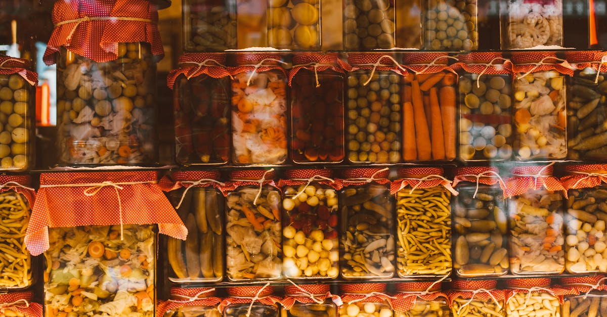 Rows of colorful preserved vegetables in glass jars, showcasing variety and abundance.