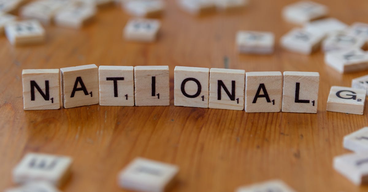 Wooden letter tiles spell 'National' on a wooden table.