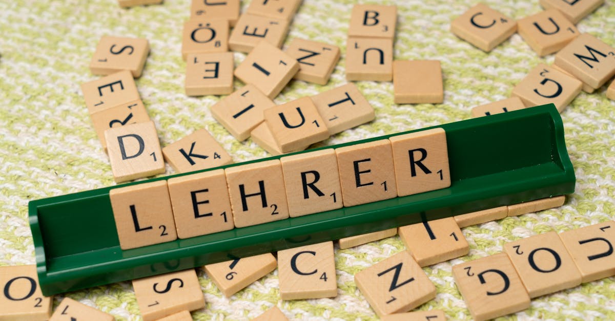 Wooden letter tiles spelling 'Lehrer' on a green rack, surrounded by scattered tiles.