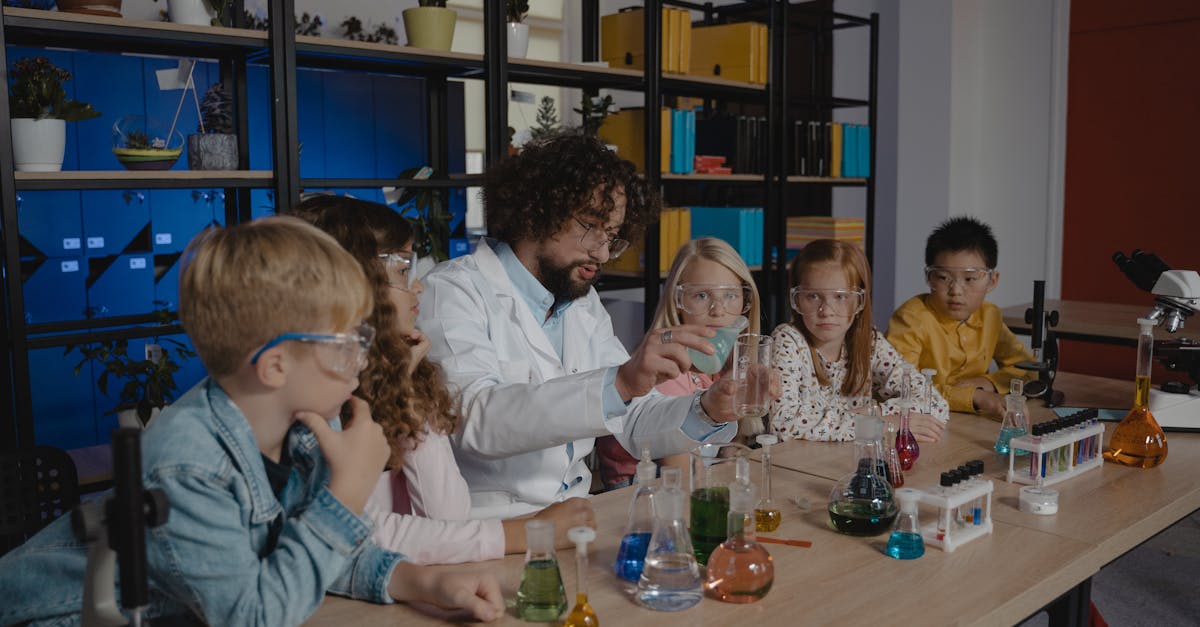Students explore chemistry experiments with a teacher guiding them in a classroom.
