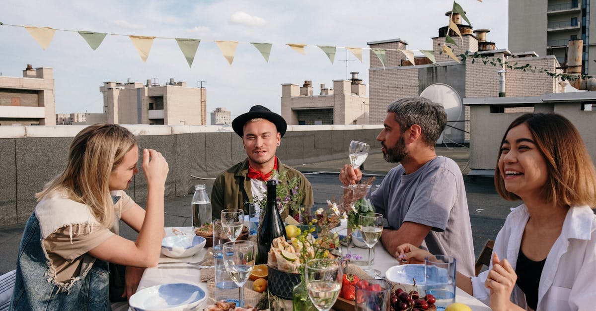 A vibrant rooftop summer gathering with friends enjoying food and drinks.