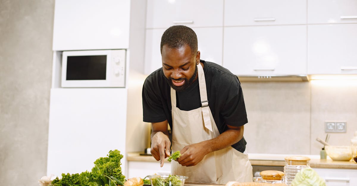 A chef in a kitchen preparing a fresh salad with vegetables, showcasing culinary skills.
