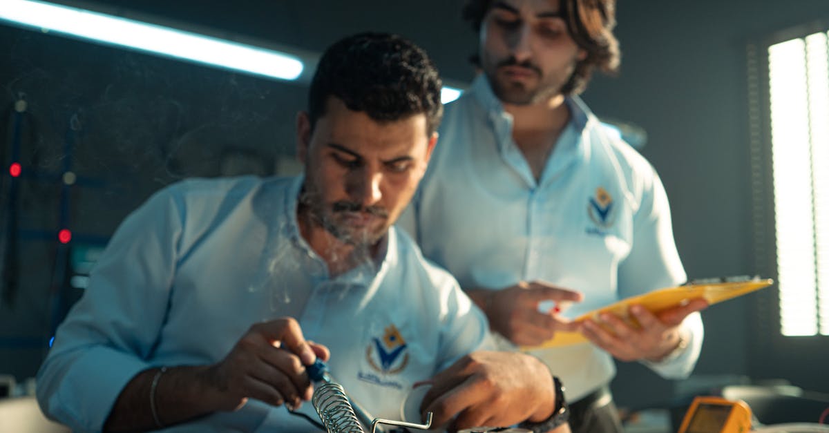 Two engineers focused on electronics assembly in a workshop in Baghdad, Iraq.