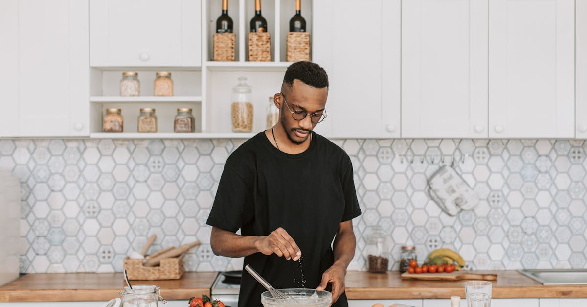 A man preparing batter with fresh ingredients in a modern kitchen setting.