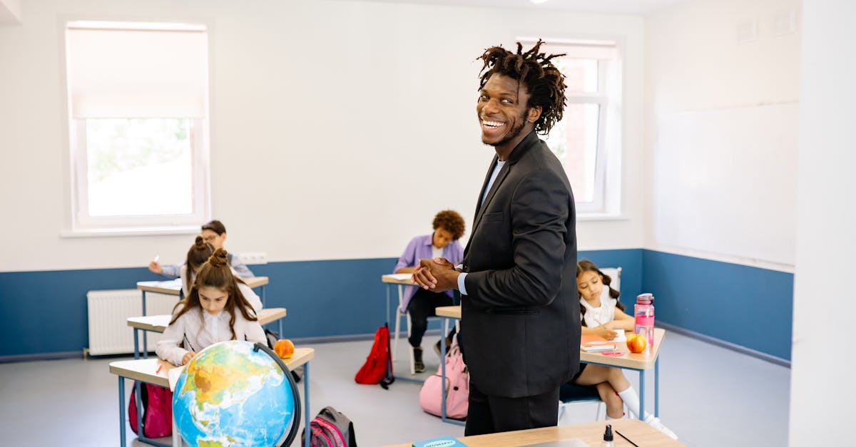 Teacher engaging with students in a bright classroom, promoting a positive learning environment.