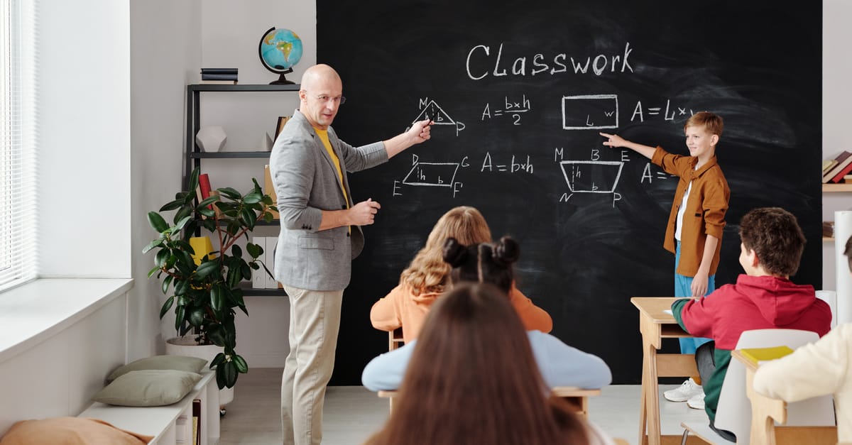 A teacher and students in a classroom during a geometry lesson, focused and engaging.
