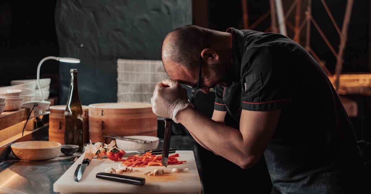 Chef focused on chopping vegetables in a restaurant kitchen ambiance.