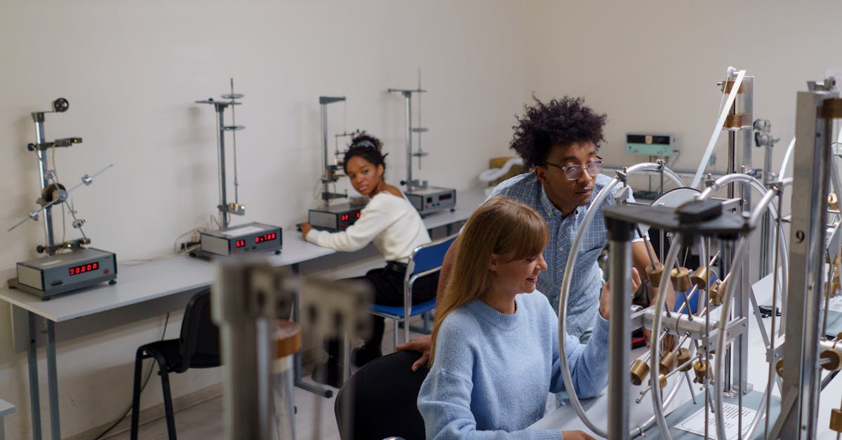 University students conducting physics experiments in a science laboratory, collaborating and learning in an interactive setting.