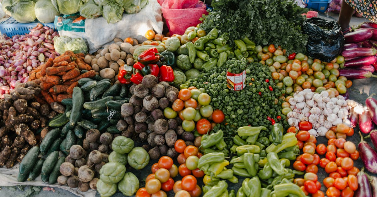 From above of various vegetables including pepper beets cabbage tomatoes greens potato zucchini and carrot at bazaar