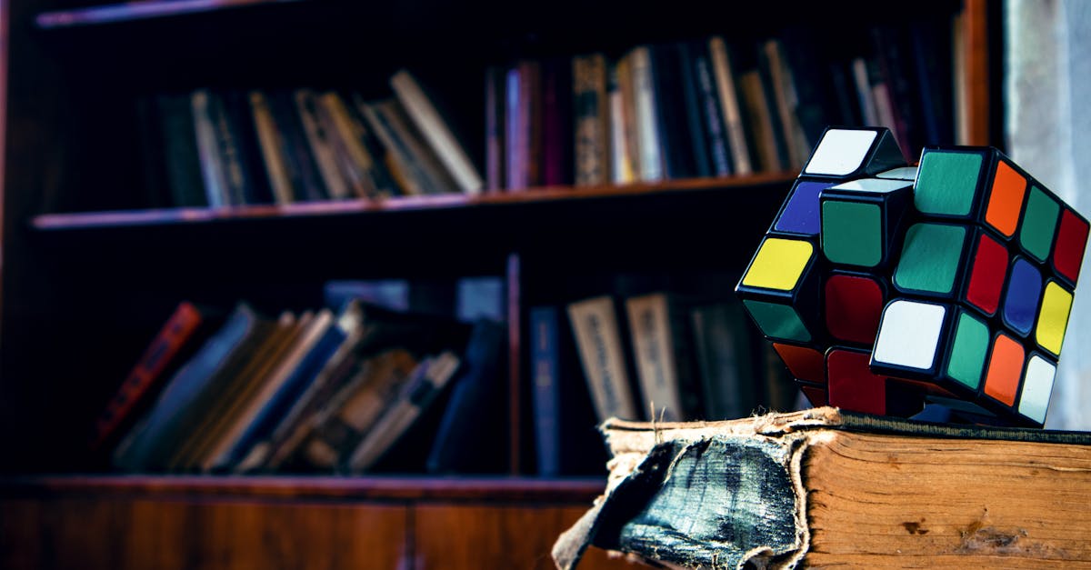 A vivid Rubik's cube resting on a worn book in a cozy library setting.