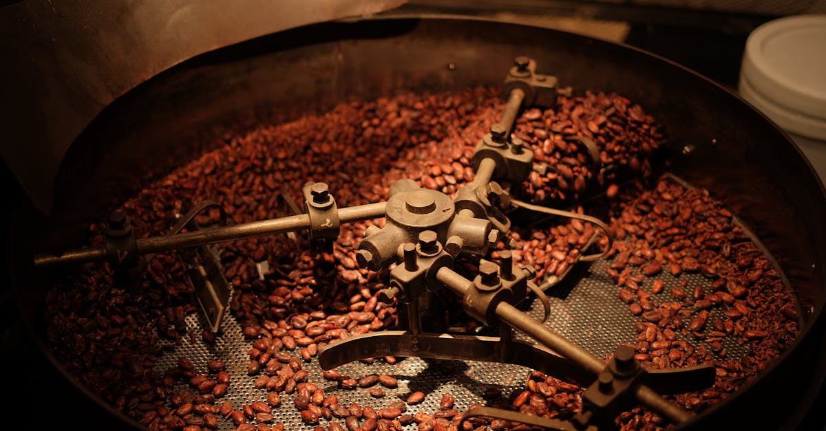 Detailed view of coffee beans roasting in an industrial roaster, showcasing the roasting process.