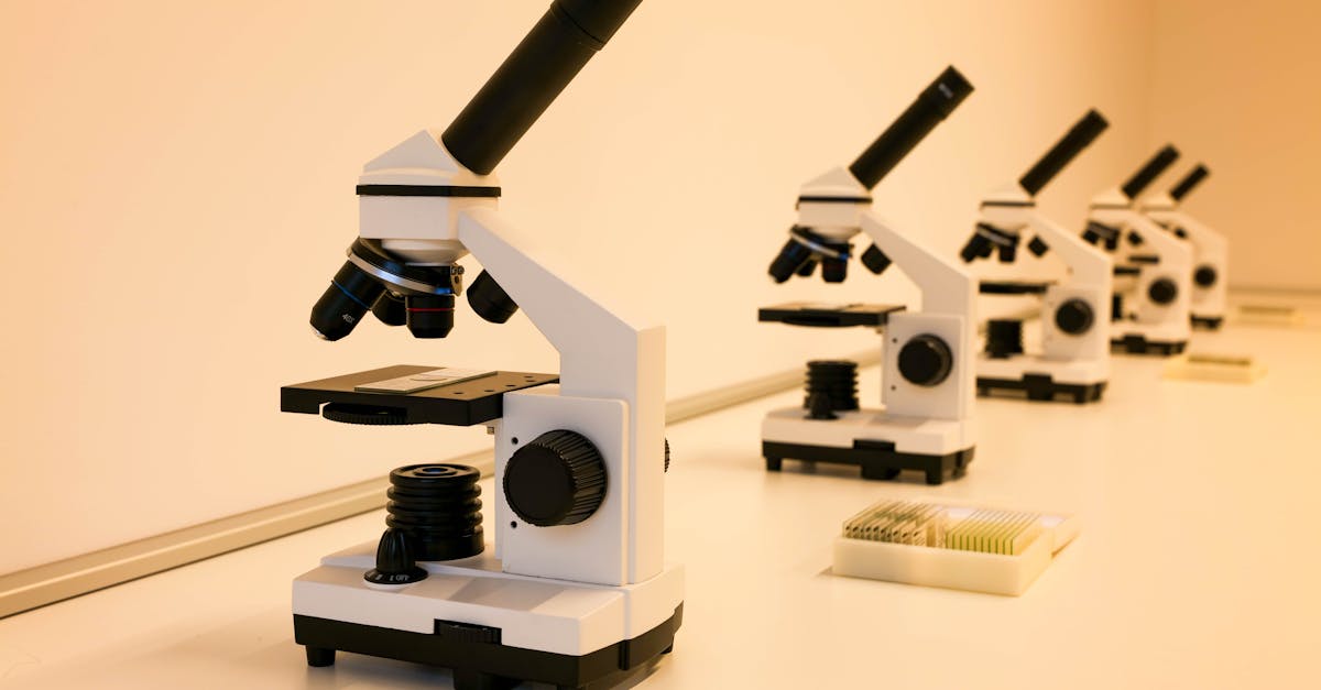 A series of microscopes on a lab table, ideal for scientific research and education.