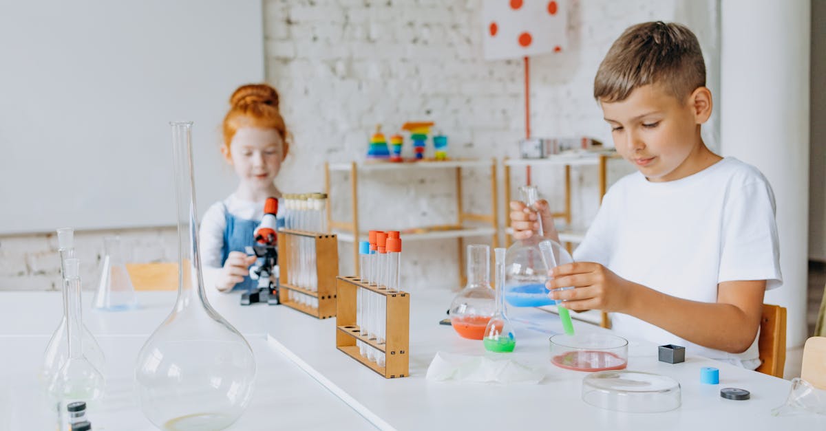 Young students engage in science experiments using a microscope and test tubes in a laboratory classroom.