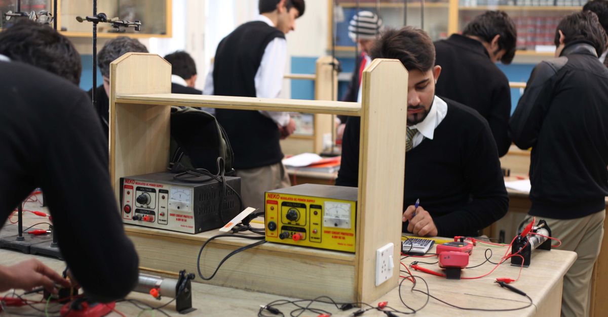 Students working on electronics projects in a lab, focusing on practical learning.